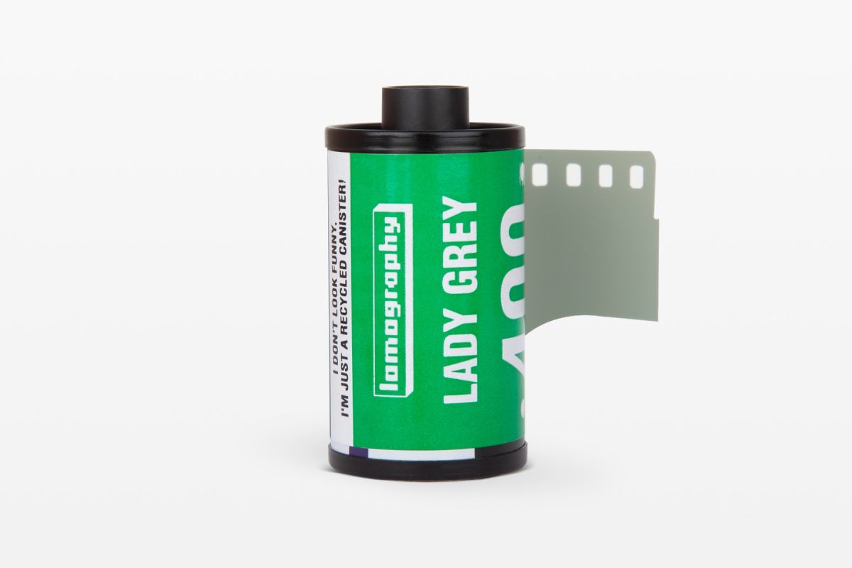 Film canister with green label on a white background