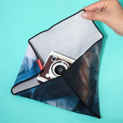 Camera case with a camera inside on a turquoise background
