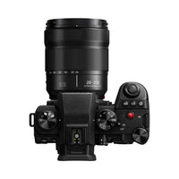 Black camera with lens on a white background