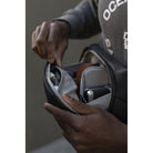 Person opening a car door with a focus on the hand and car door handle.