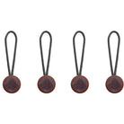 Four brown leather tags with strings on a white background