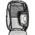Camera equipment inside an open backpack on a white background