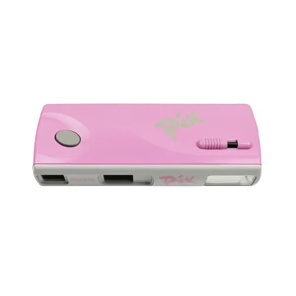 A pink Pix digital camera with a gray base, featuring a glossy pink top cover with a silver button, a pink lens cover, and a pink power switch.