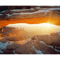 Portra 400 image of a sunset over a desert landscape with rock formations and snow