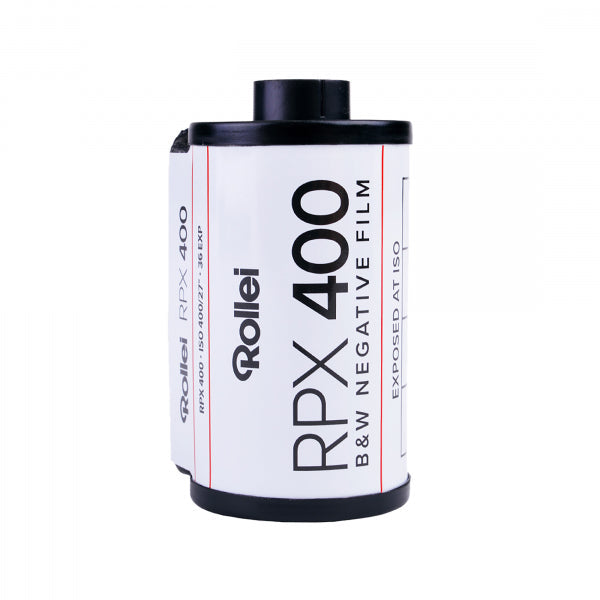 A roll of Rollei RPX 400 B&W Negative Film film canister, featuring a white label with black text and red accent lines, set against a plain white background.