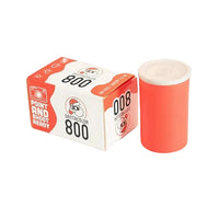 Red and white camera film canister with packaging on a white background