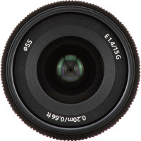 A close-up studio shot of a black Nikon AF-S DX NIKKOR 18-55mm f/4G lens, showing the front glass elements, textured focus ring, and white printed specifications including 'E1.4/1.