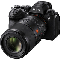 Sony camera with large macro 100mm lens on a white background