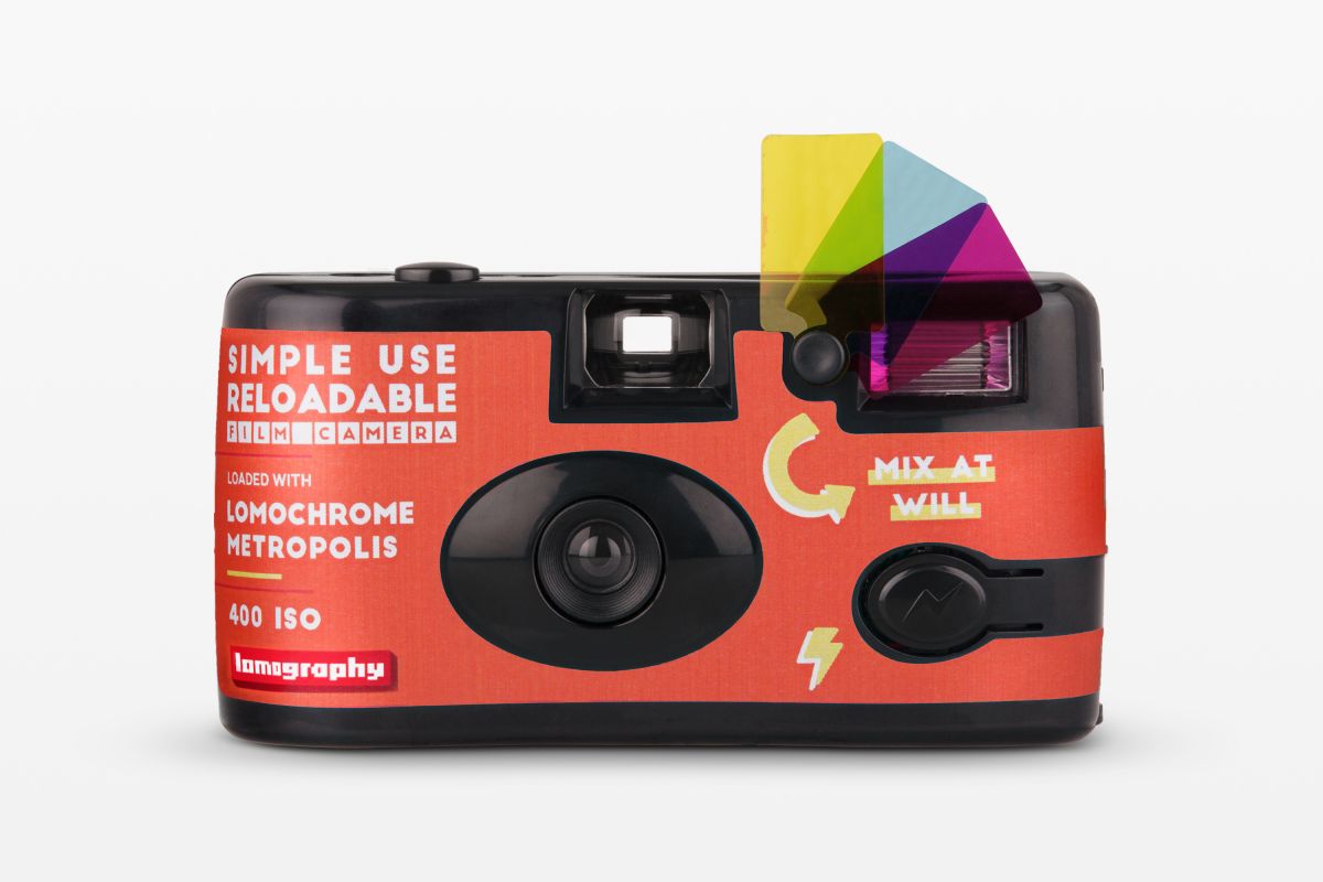 Red camera with colorful lens shade on a white background