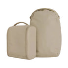Two beige travel bags with 'Urth' branding on a white background