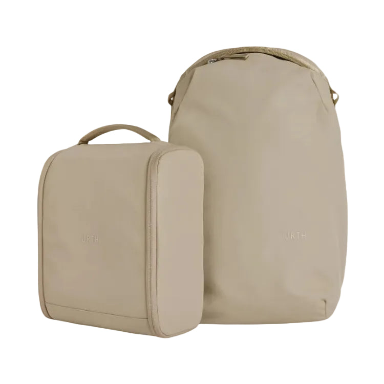 Two beige travel bags with 'Urth' branding on a white background