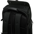 Close-up of a black backpack with visible branding on a white background