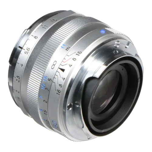 Close-up of a camera lens with metallic finish on a white background