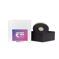 A package of Kentmere 400 35MM film with a small sample frame of the film roll visible, displayed on a black stand.