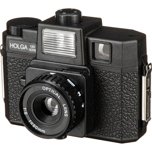 Black Holga 120GCFN medium format film camera with a 60mm glass lens, built-in flash, and textured plastic body.