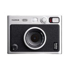 A brown and silver FUJIFILM Instax Mini EVO Hybrid Instant Camera with lens effects and manual print lever.