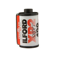 A roll of Ilford XP2 Super ISO 400 film, showing the white label with red and black text and a red side clip, isolated on a white background.