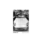 Black and white photograph of a sports car in a garage, showcasing the sharp contrast and fine grain of Kentmere 400 film.