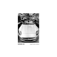 Black and white photograph of a sports car in a garage, showcasing the sharp contrast and fine grain of Kentmere 400 film.