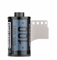 A photograph of a Lomography Earl Gray 100 Black and White Negative Film roll for 35mm cameras.