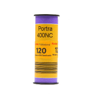 A single roll of Kodak Portra 400 120 color film in a purple and yellow packaging.