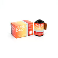 A product image showing a box and roll of Amber D400 35mm film, with packaging that indicates it is a 27-exposure roll, ISO 400, and daylight-balanced.