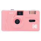 Pastel pink Kodak M35 35mm reusable film camera with a fixed-focus lens, built-in flash, and optical viewfinder.